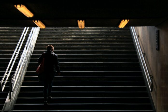 man at dark stairs