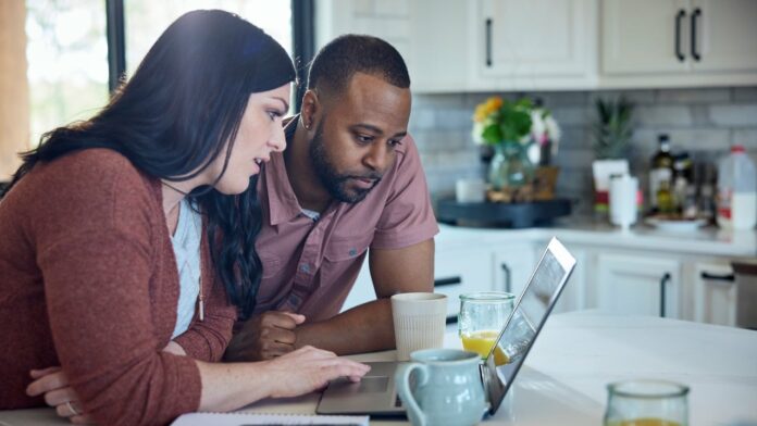 couple looking at laptop for cooking recipes