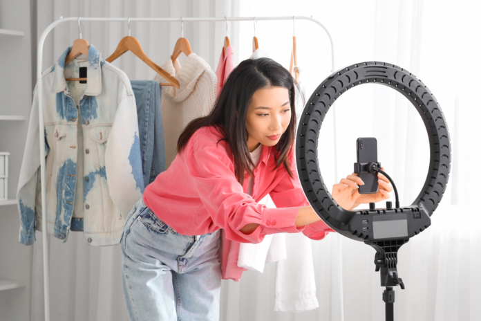 Young Asian woman getting ready to record a video for TikTok.png